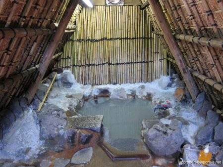 Bain thermal privé en pierre dans une cabane à Beppu